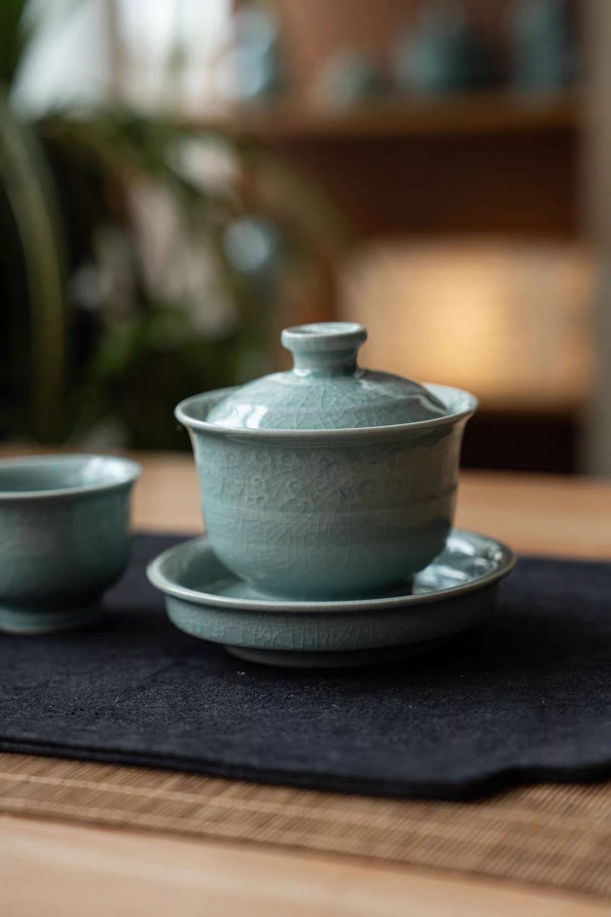 Stack of matching powder-celadon crackle teacups showing their compact nesting design.