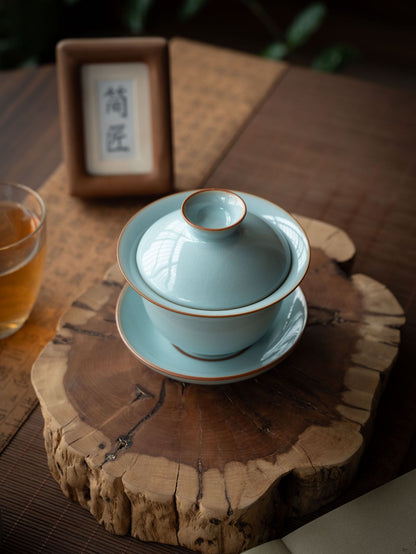 Close-up of Ru Kiln sky-blue lidded gaiwan showing agate glaze luster and metallic bronze lip