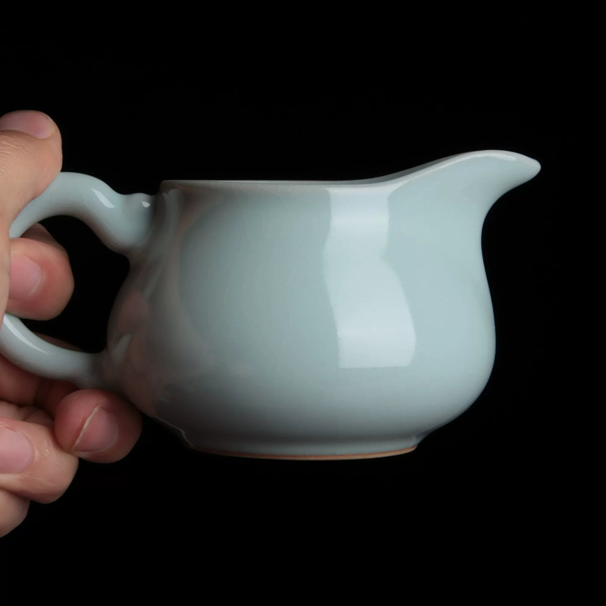 Close-up of the smooth sky-cyan azure glaze finish on the handcrafted Ru Kiln teaware.