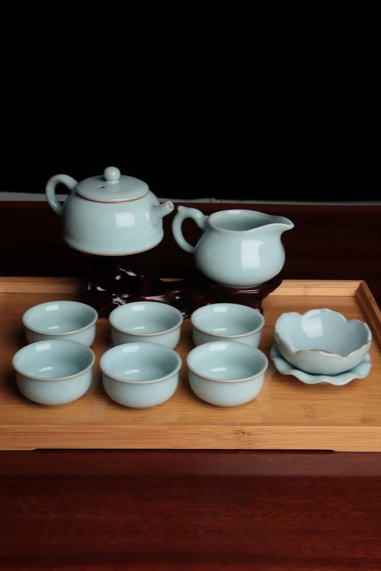 Row of six matching Ru Kiln sky-cyan teacups showing uniform shape and glaze quality.