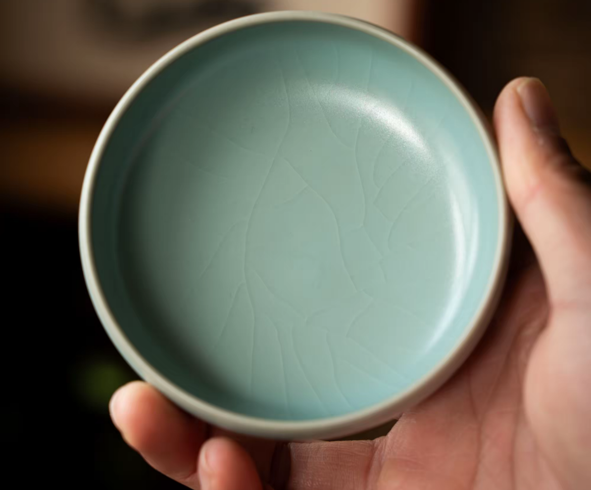 Side view of Ru kiln sesame nail teacup highlighting handcrafted ceramic texture