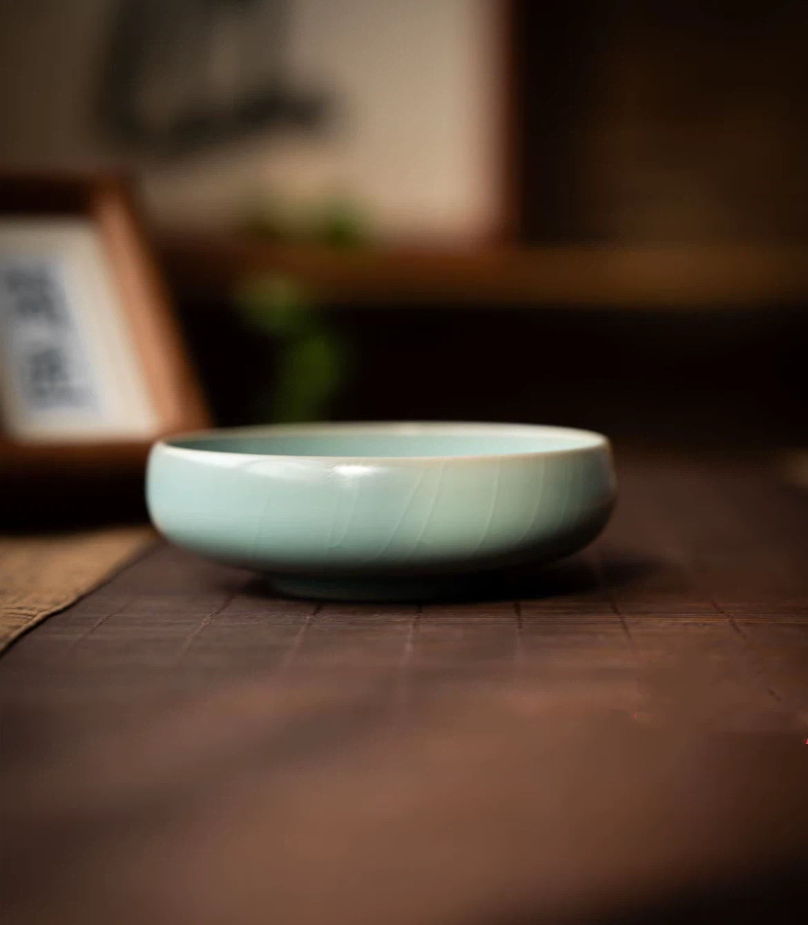 Close-up of handmade Ru kiln large teacup featuring sesame nail marks and carved willow leaf motif