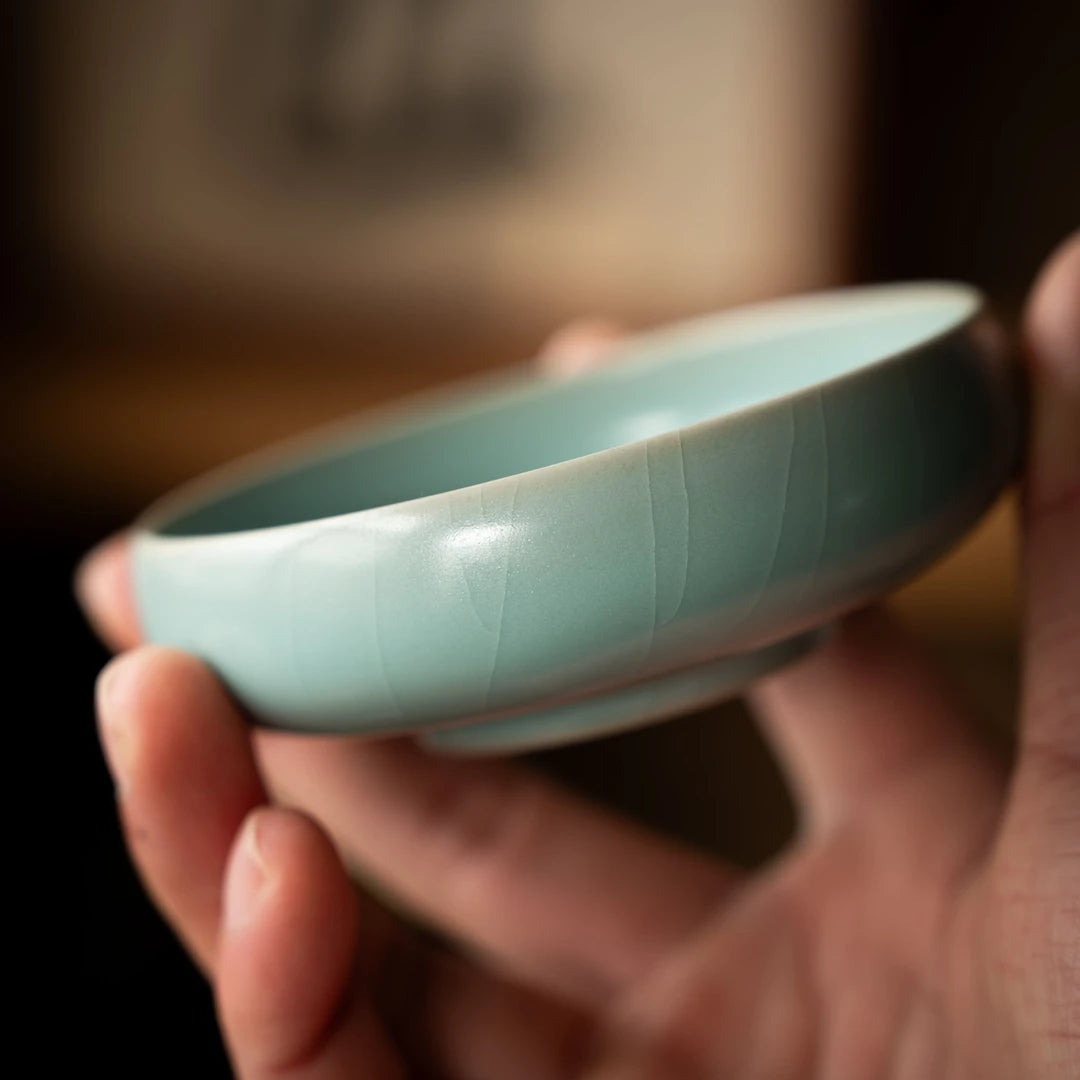 Artisan Ru Ware willow leaf pattern teacup displayed on a tea table setting