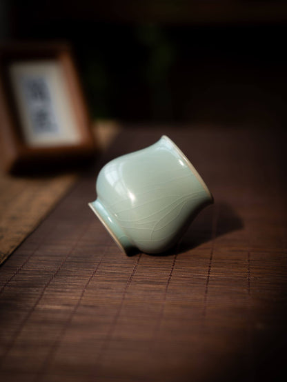 Song Dynasty style celestial blue glazed porcelain cup held in a person's hand.