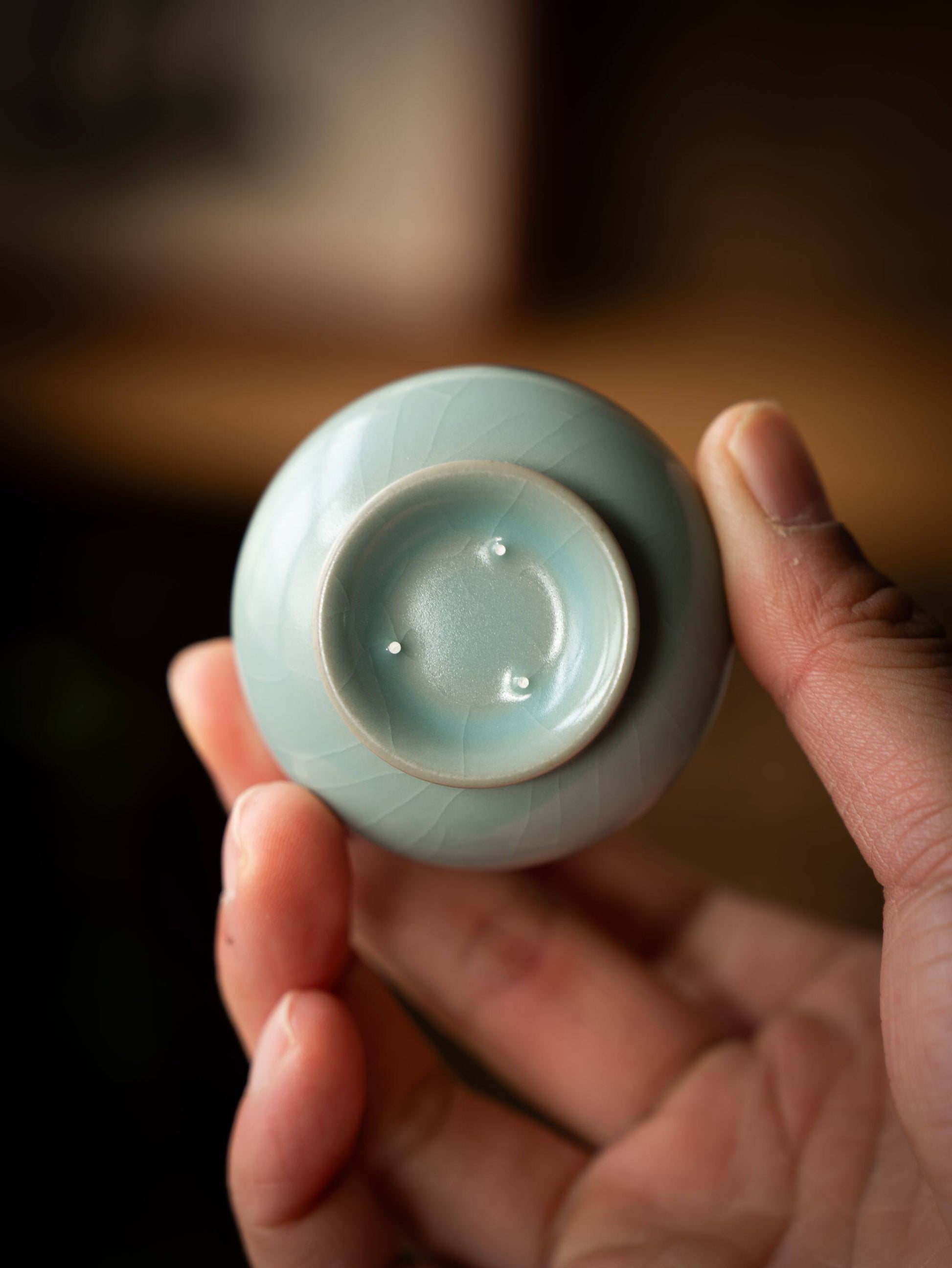 Ergonomic flared rim of a handmade magnolia-shaped master cup for Gongfu tea.