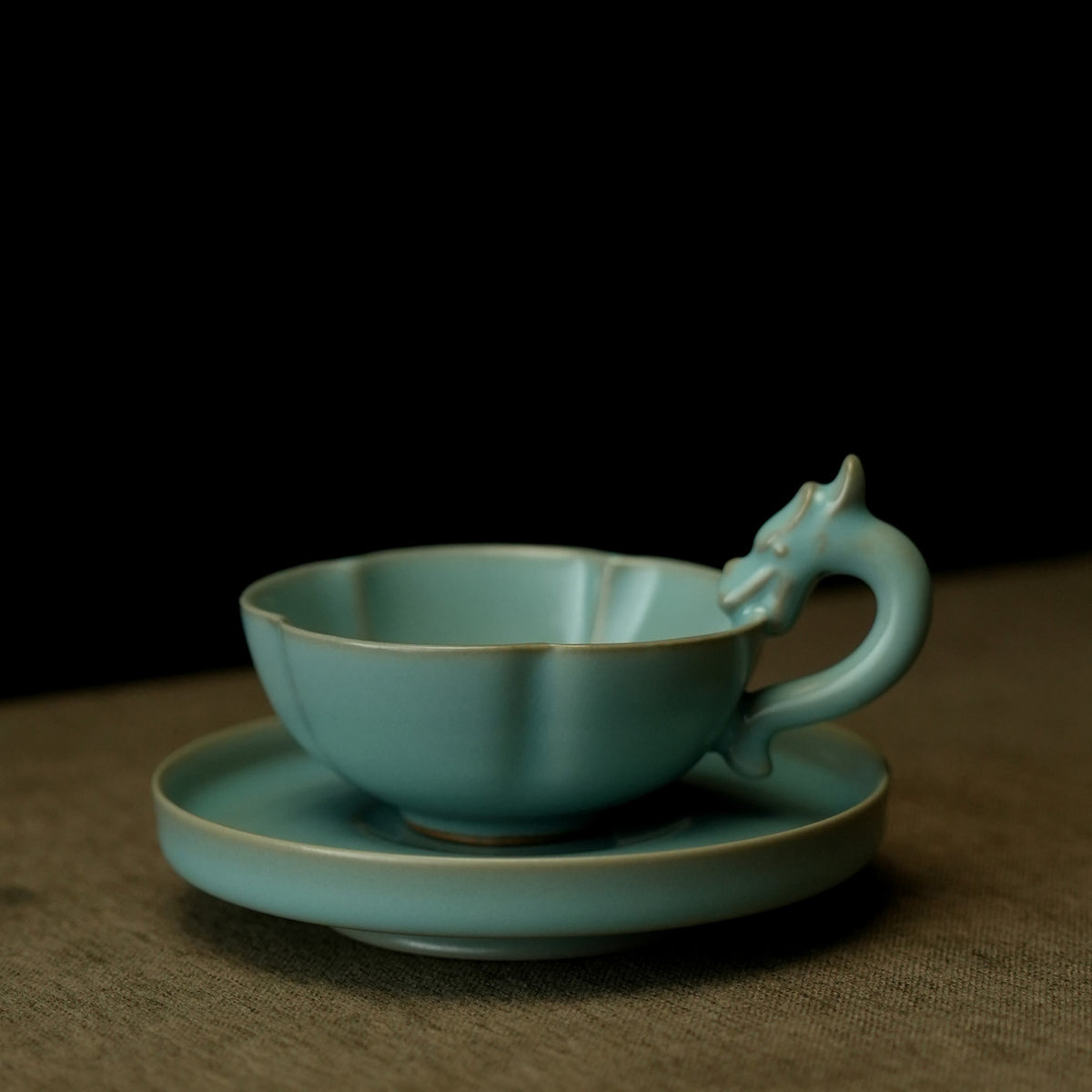 Close-up of sculpted 3D dragon-head handle and celestial blue crackle glaze on Ru Ware cup   