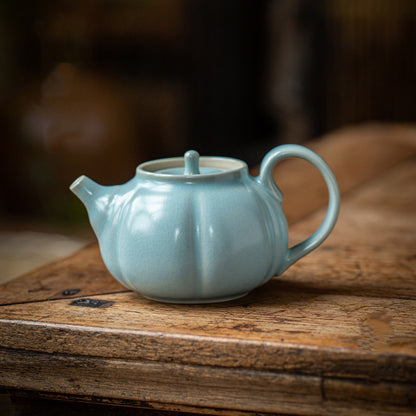 Ru Ware sky-blue glaze pumpkin shape teapot 200ml resting on dark rustic wood tea table