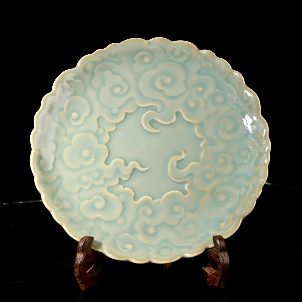 Ru Ware sky-blue glazed auspicious cloud embossed teapot tray resting on rustic dark wood table