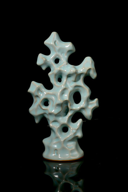 Close-up of perforated hollows and jade-like sky-blue glaze on Ru kiln Gongshi stone statue