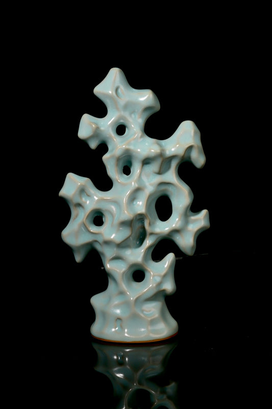 Close-up of perforated hollows and jade-like sky-blue glaze on Ru kiln Gongshi stone statue