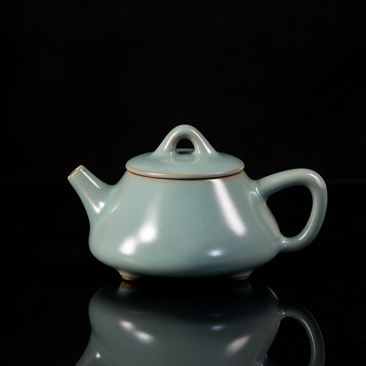 Ru Ware sky-blue glazed three-legged Shipiao teapot resting on rustic brown woven mat