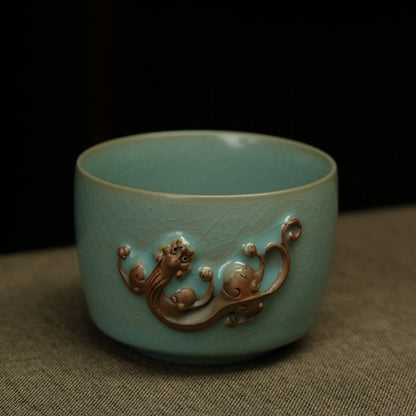 Close-up of 3D sculpted terracotta Chi dragon motif and celestial blue crackle glaze on master cup