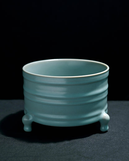 Ru ware Zun showing incense ash clay body through thin glaze areas at raised patterns