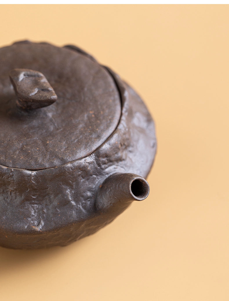 Side angle of rustic wood-fired wabi-sabi teapot