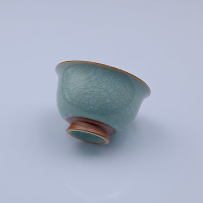 Incense-ash clay teacup with natural glaze cracks developed through controlled cooling