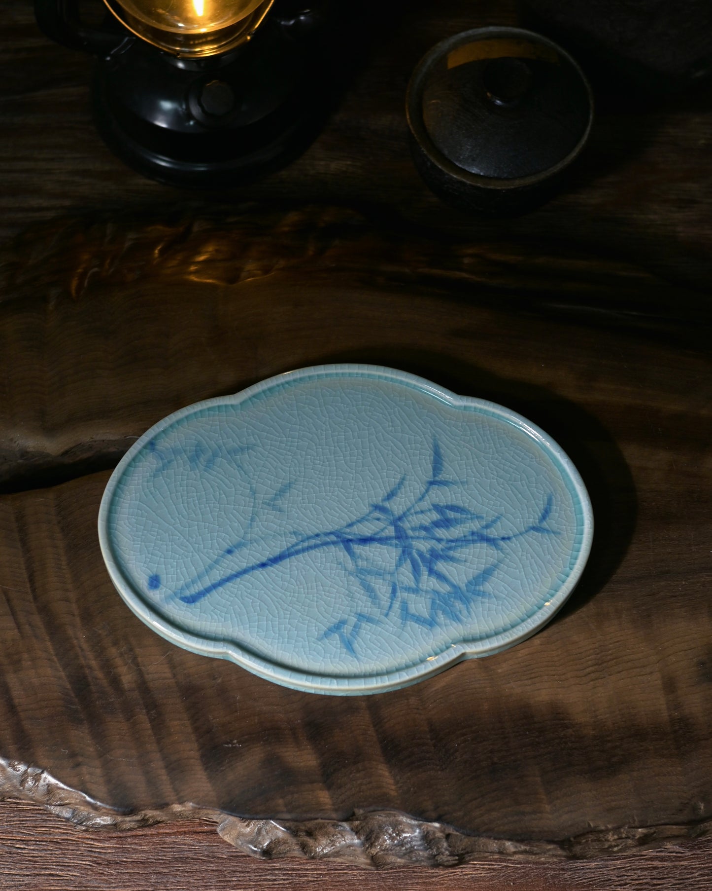 Antique-style blue and white porcelain saucer, showing its shallow, balanced form, warm glaze, and suitability as a teaware saucer or table ornament.