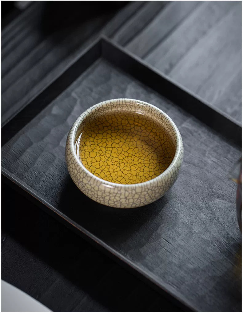 Subtle sheen and deep crackle glaze of an artisan Ge Kiln style tea bowl under natural light