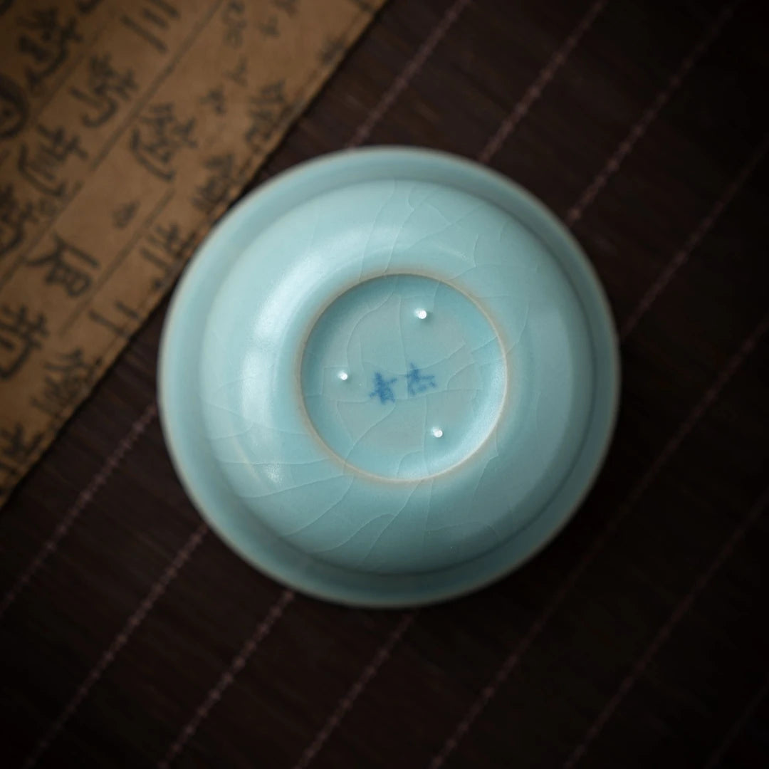 Side view of Ru Ware teacup showing sesame nail marks and crackle glaze