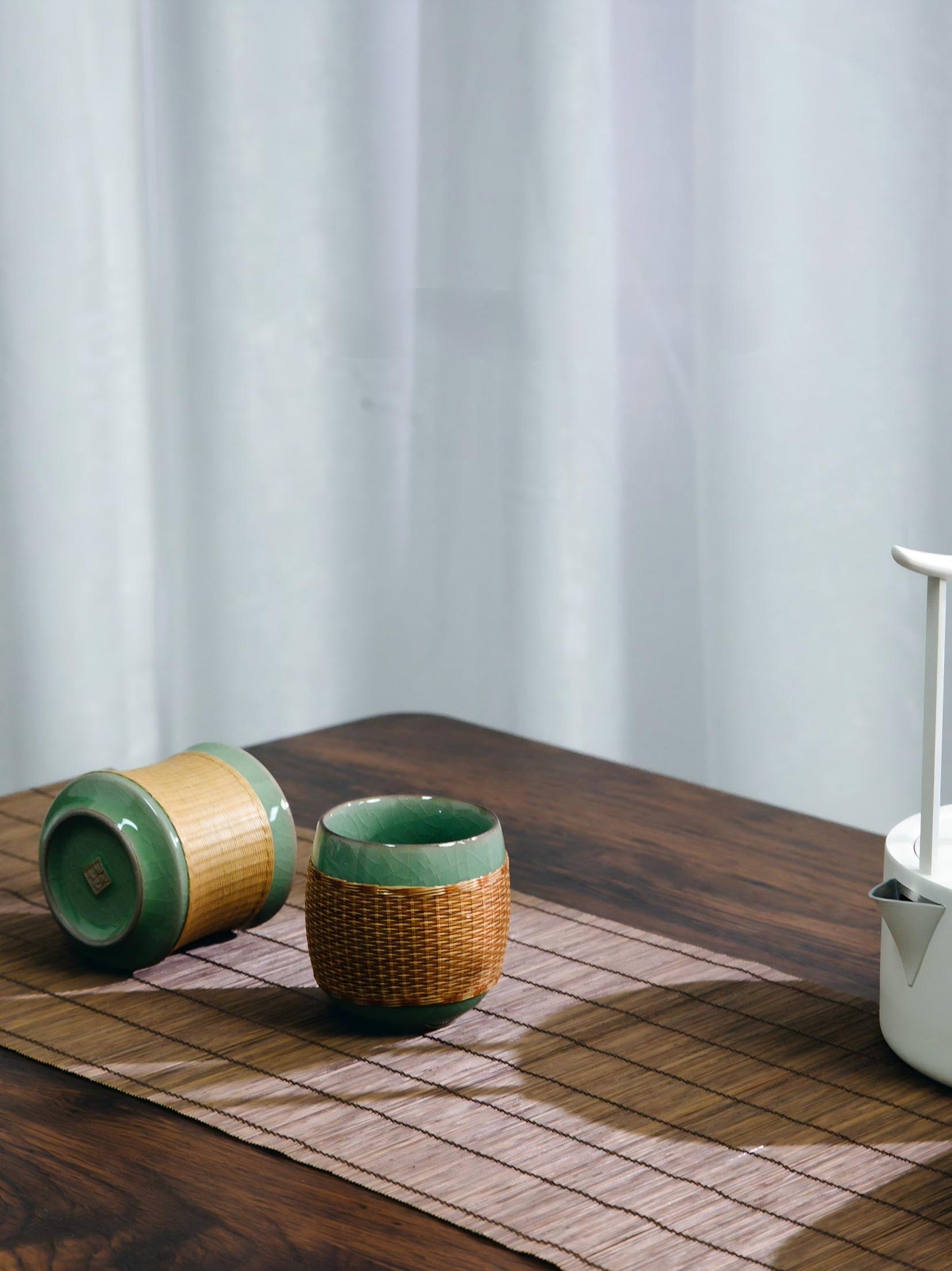 Saanwu Studio bamboo‑joint Longquan Ge‑Yao celadon teacup fitted with hand‑woven bamboo sleeve, handmade Chinese tea collectible