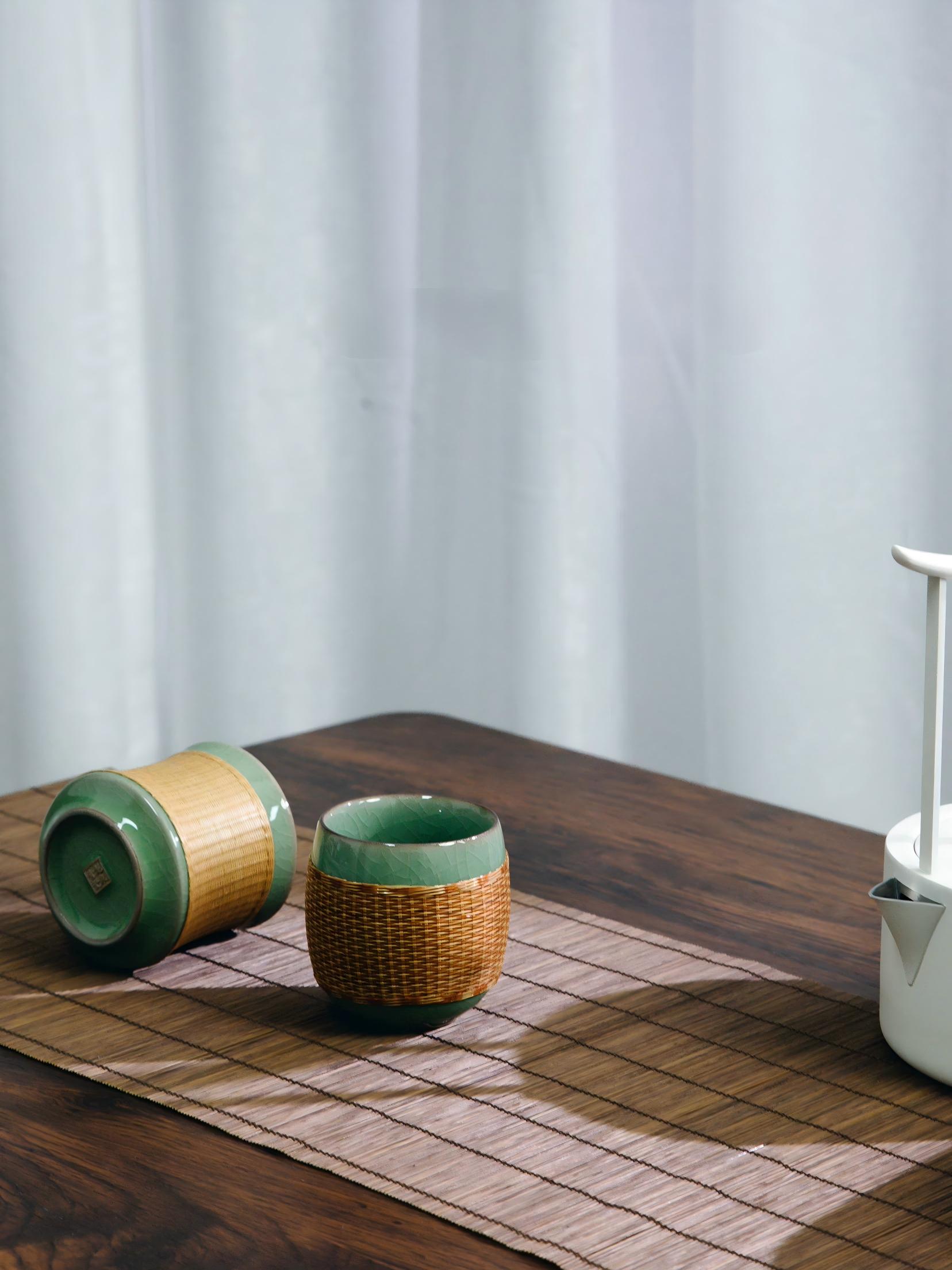 Saanwu Studio bamboo‑joint Longquan Ge‑Yao celadon teacup fitted with hand‑woven bamboo sleeve, handmade Chinese tea collectible