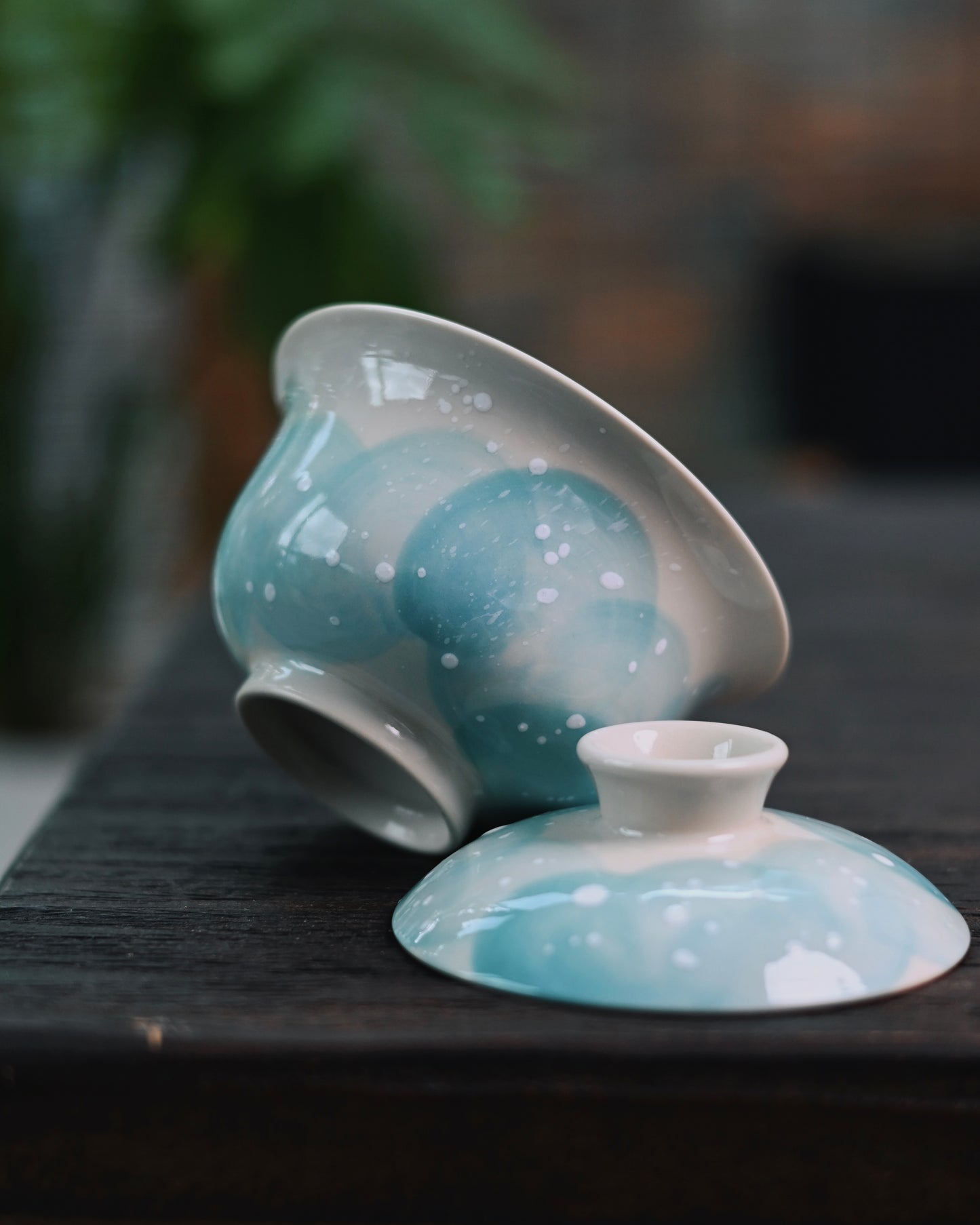 Detailed underglaze decoration showing sketched blue landscape with sprinkled snowflake accents