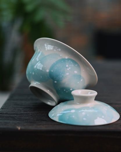 Detailed underglaze decoration showing sketched blue landscape with sprinkled snowflake accents
