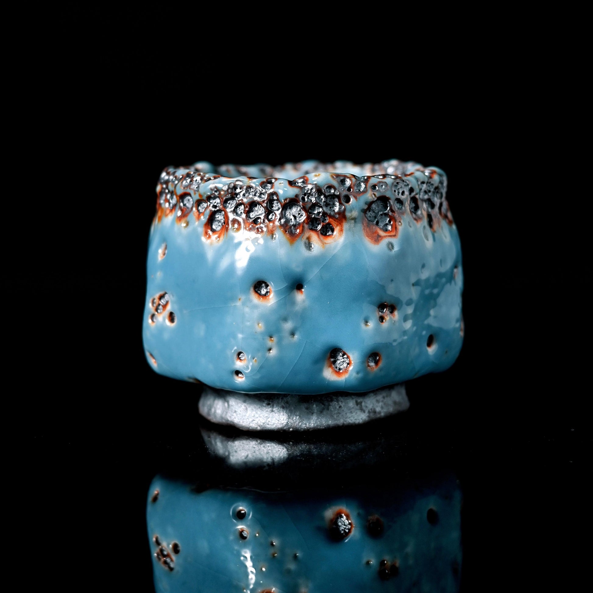 Shino ware kiln-transformation teacup featuring spontaneous sapphire blue glaze variations