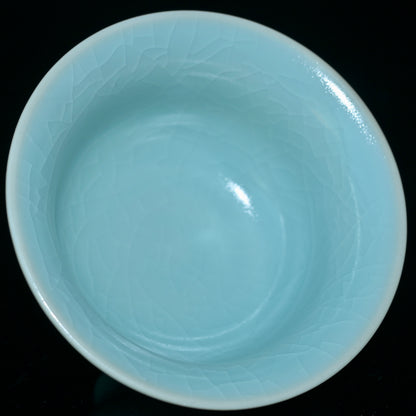 Song Dynasty style Ru porcelain tea cup with monochromatic glaze and evolving crackle patterns from tea soaking