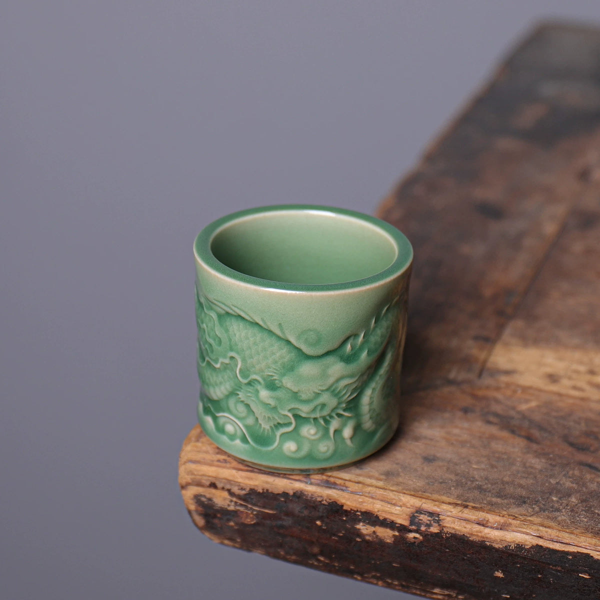 Side profile of Longquan Celadon straight cylinder teacup featuring detailed dragon motif