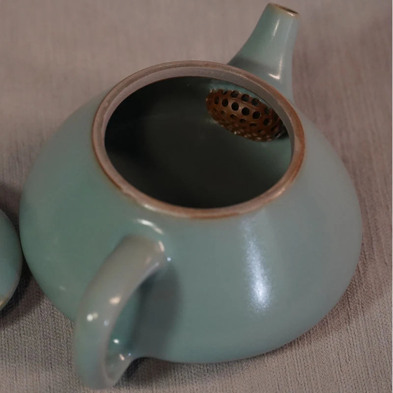 Side profile of Ru kiln sky-blue Shipiao teapot showing straight spout and ergonomic handle