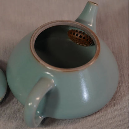 Side profile of Ru kiln sky-blue Shipiao teapot showing straight spout and ergonomic handle