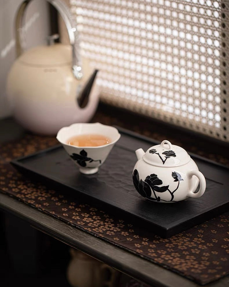 Teapot with spherical filter and ash glaze surface, decorated with elegant magnolia illustration