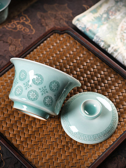 Unique jade-soft Longquan celadon tea vessel featuring light-transmitting carved floral blossoms