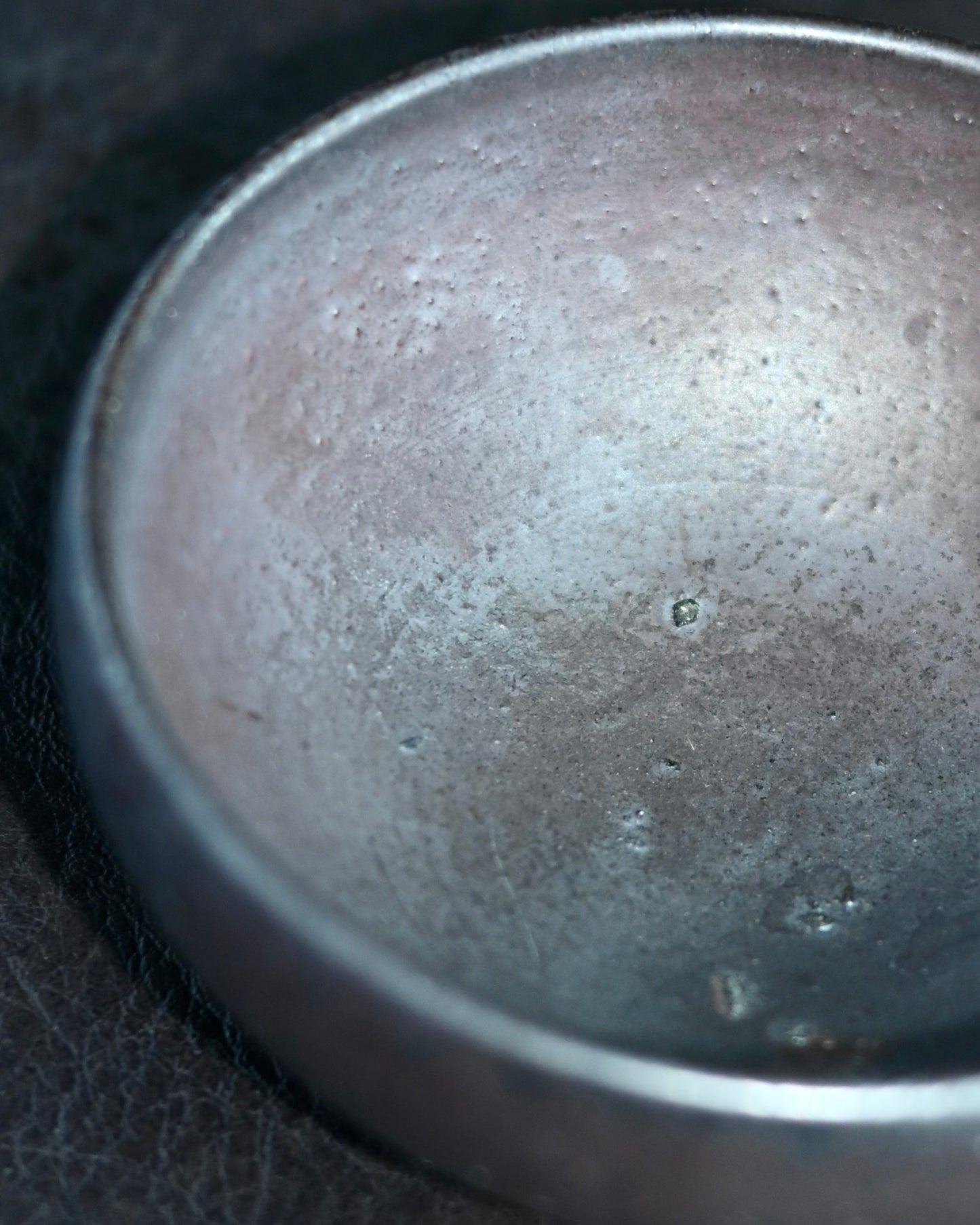 Subtle firing particles on interior surface from wood ash deposition during kiln process