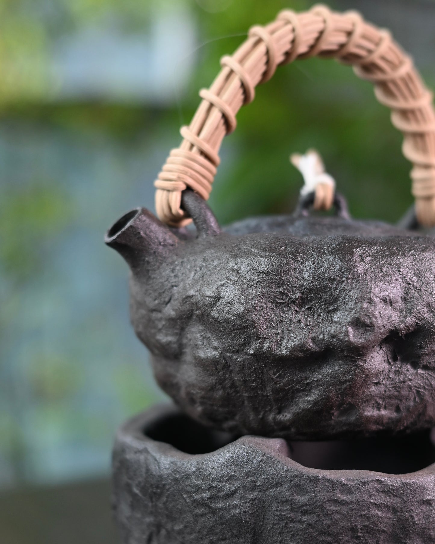 Natural tea staining patterns creating unique patina on unglazed clay surface