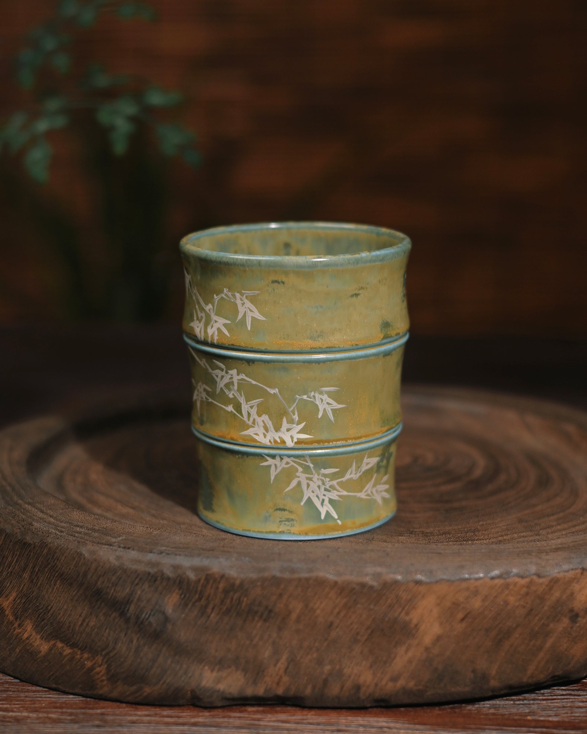 A curated collection of mugs from this Jingdezhen studio series, displaying variations in glaze effects and bamboo paintings