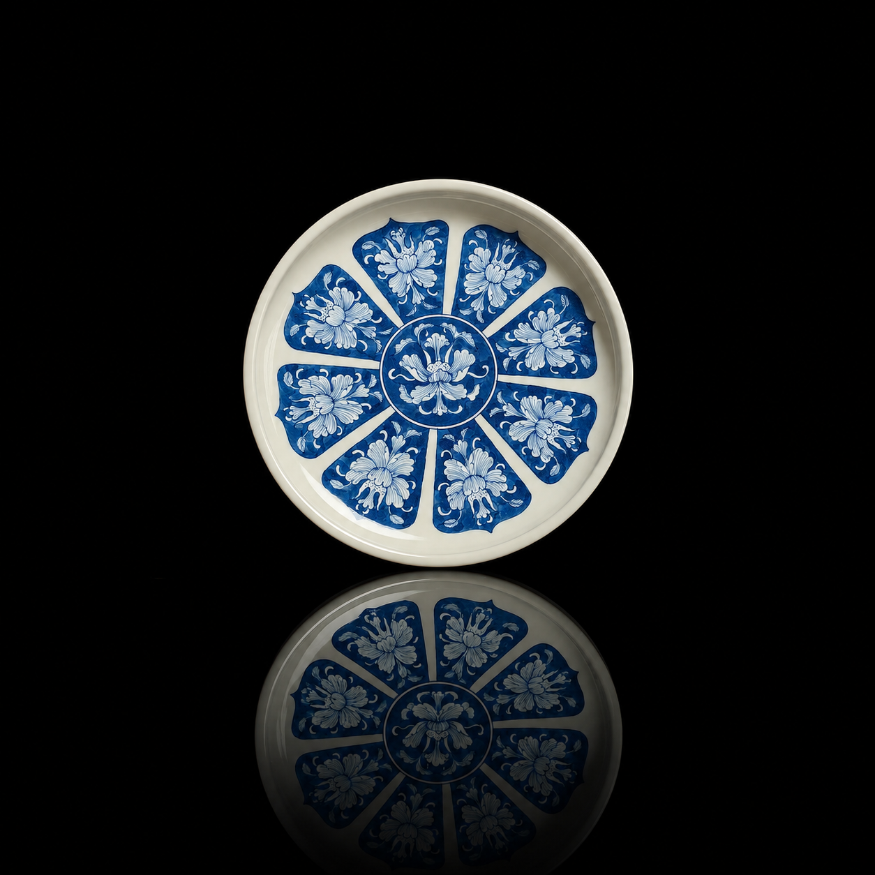Top-down view of an antique-style blue-and-white tea tray with radiating peony patterns.