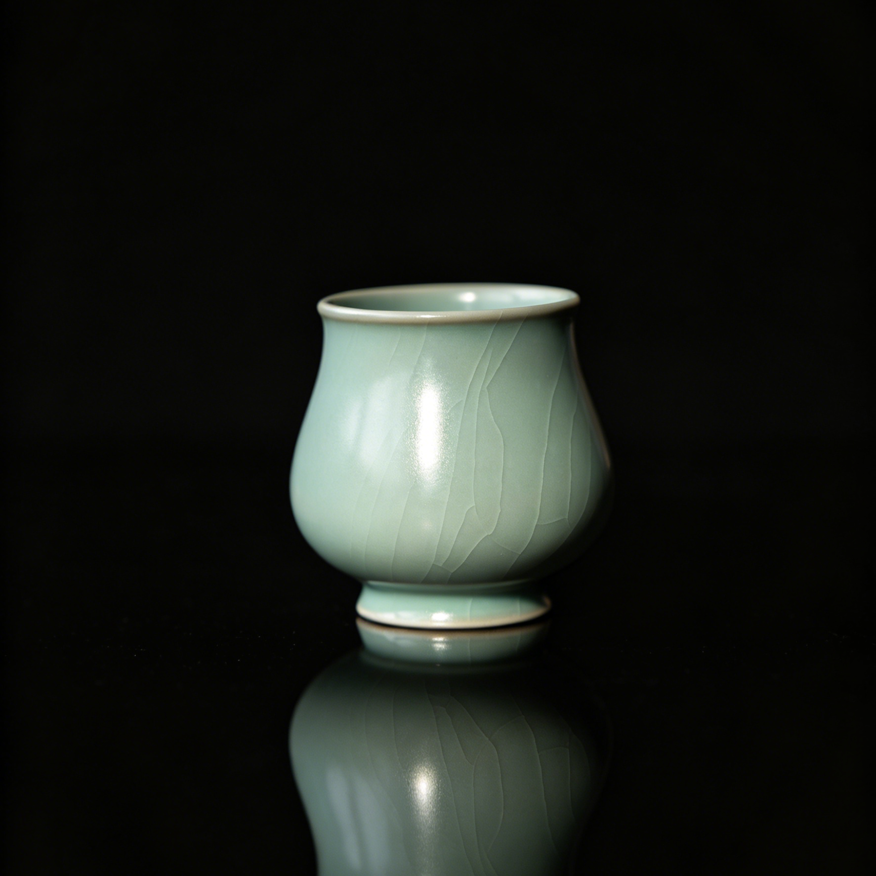 Artisan Ru Ware sky-blue teacup in an elegant magnolia flower bud shape.