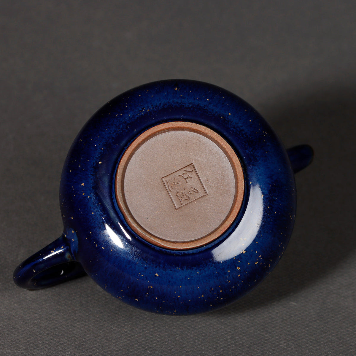 Gongfu tea setup featuring Jun Ware starry blue teapot on dark stone tea tray