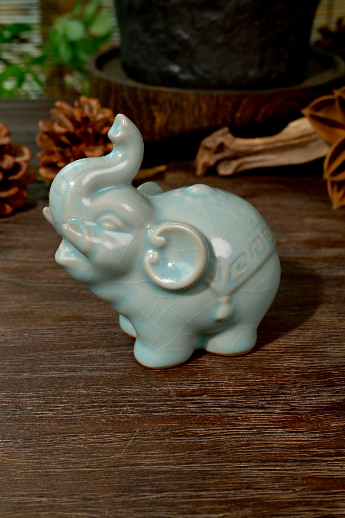 Gongfu tea setup featuring Ru Ware sky-blue elephant tea pet on rustic wooden tea table