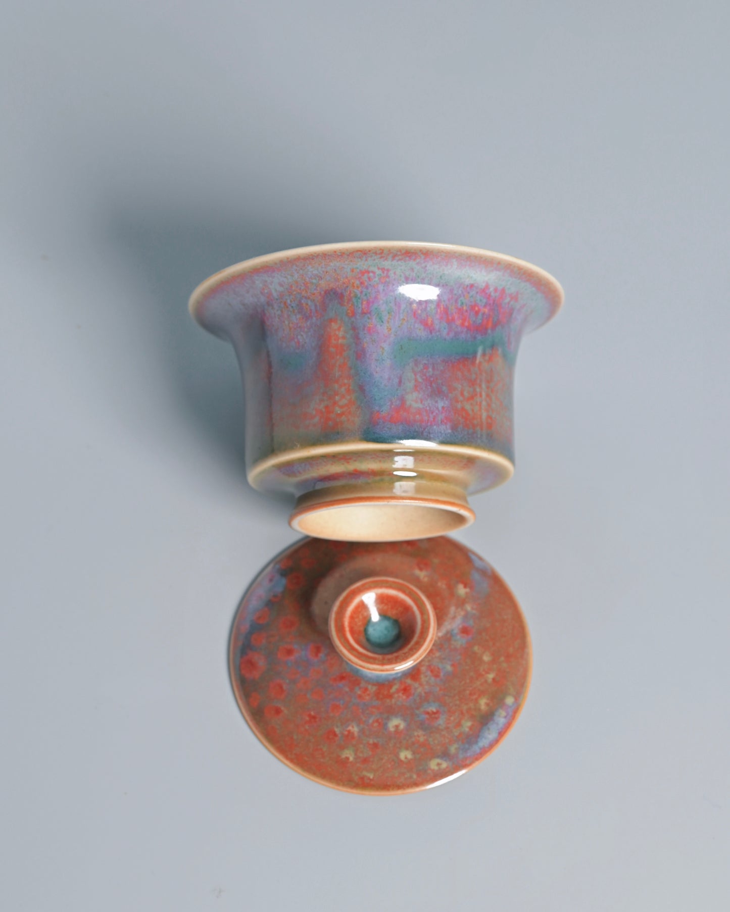 Traditional tea ceremony vessel combining functional form with Jun ware artistic expression