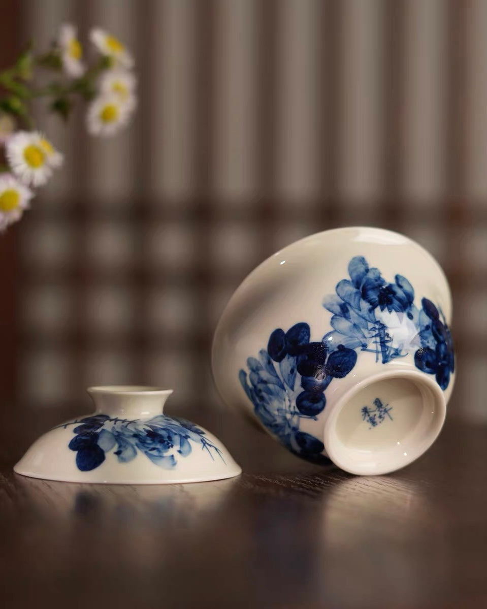Peony decoration visible inside the bowl when empty, adding discovery to tea drinking