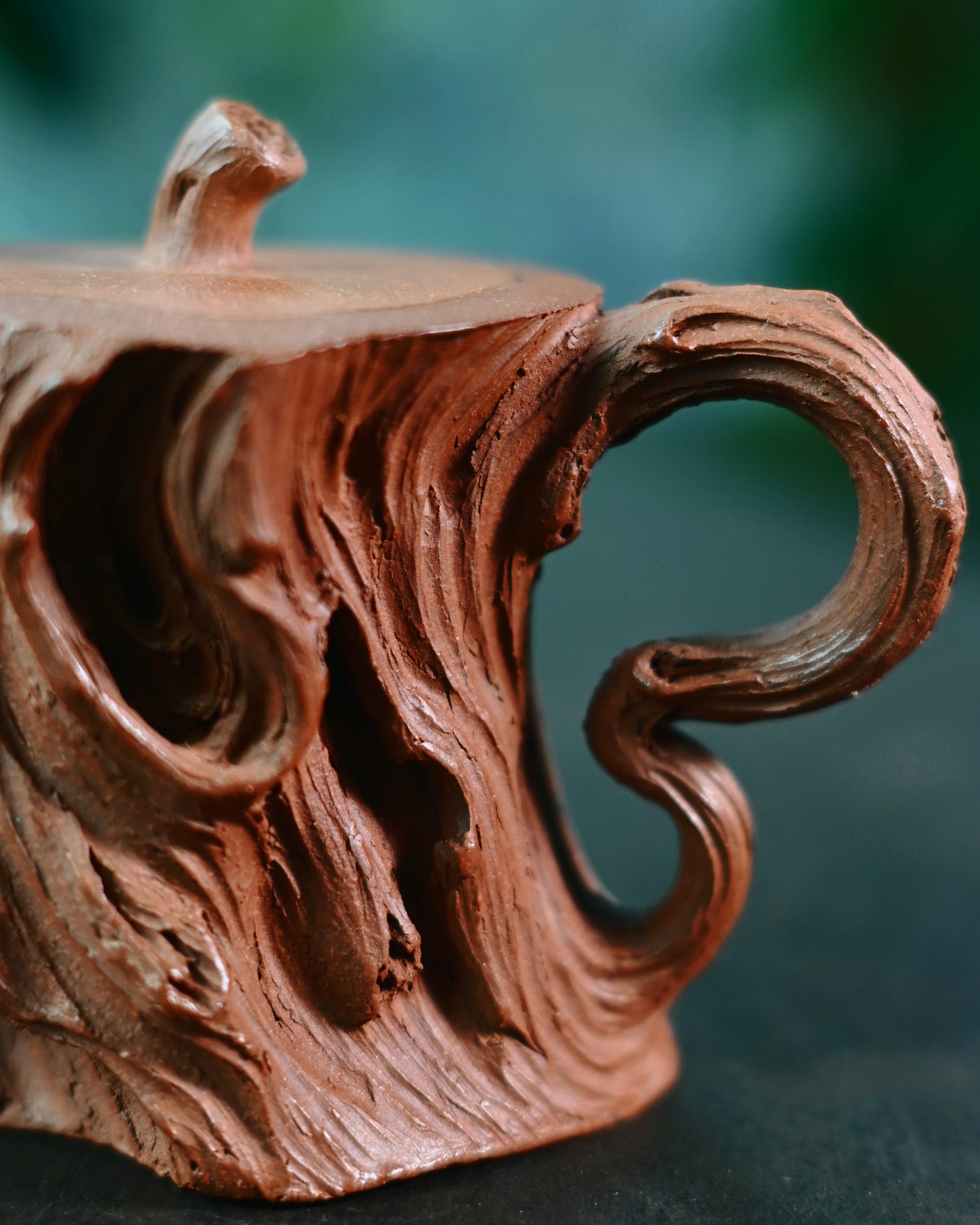 Stump teapot with slender tree branch lid knob symbolizing natural harmony