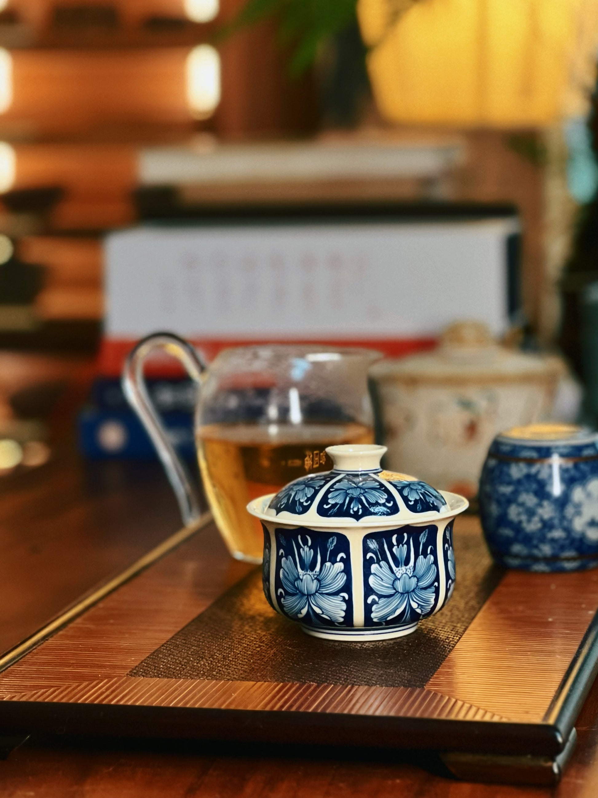 Cobalt ground lidded bowl with glossy transparent glaze and traditional floral reserved decoration