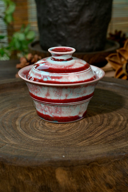 Gongfu tea setup featuring unique wood-fired flame-red bamboo Gaiwan on rustic wood base