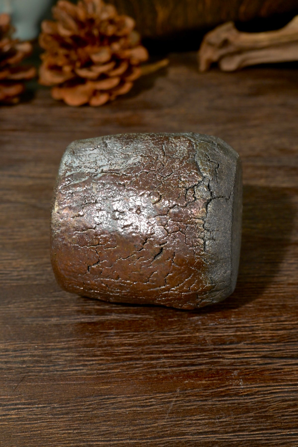 Top-down view of wood-fired teacup interior showing smooth dark iron-rich clay body