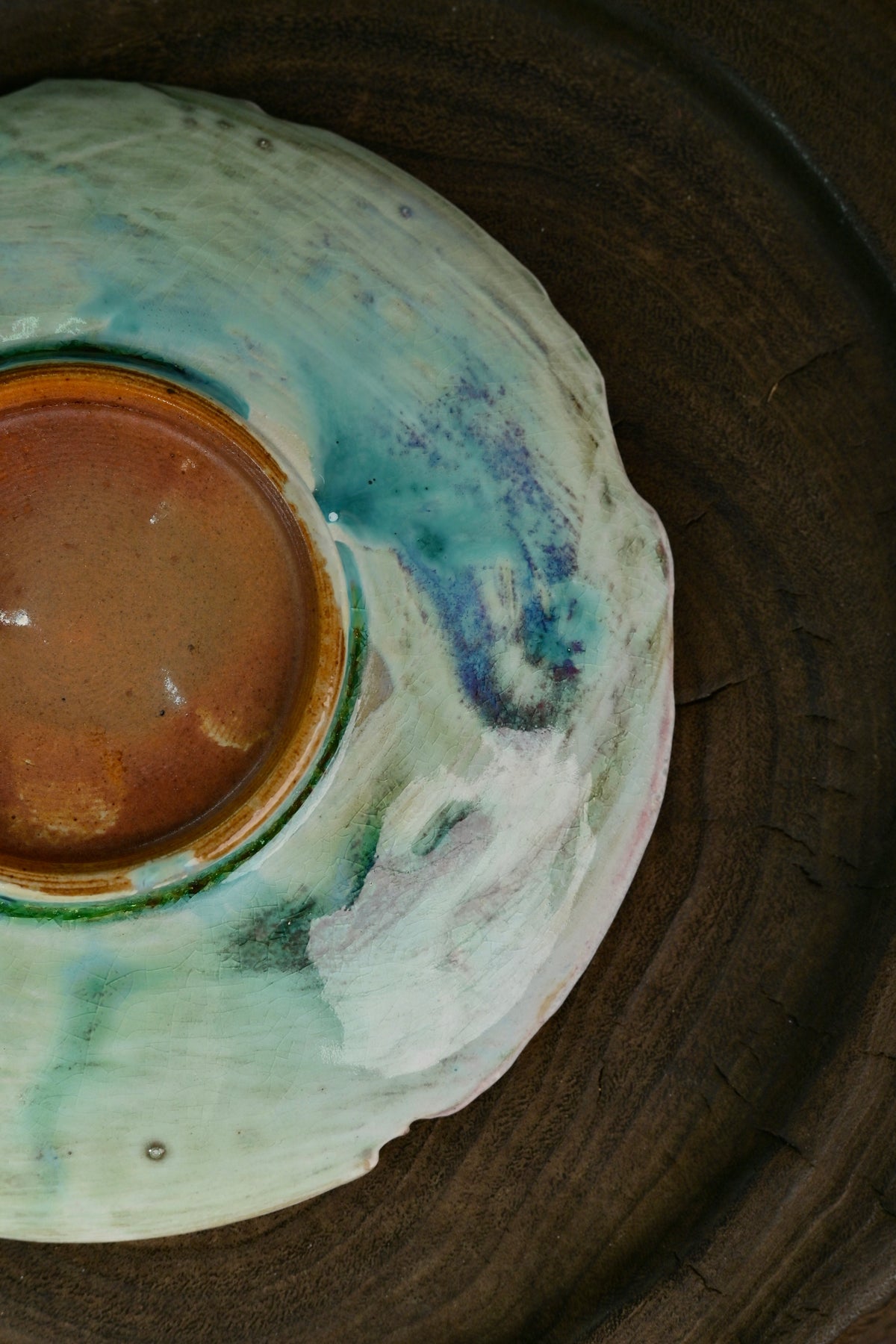 Top view of soda-fired organic rim tea saucer showing smooth glaze and crackle texture