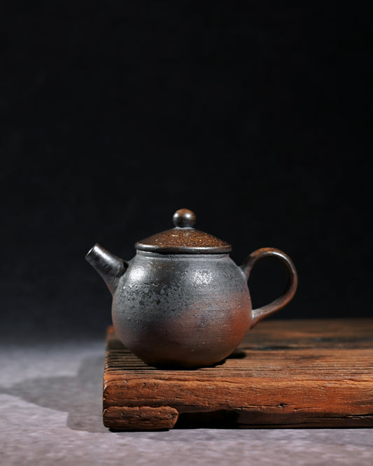 Raw coarse clay teapot embodying wabi-sabi rustic simplicity and unadorned ancient beauty