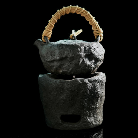 Wabi-sabi style rough pottery teapot and charcoal stove set showcasing handmade imperfections