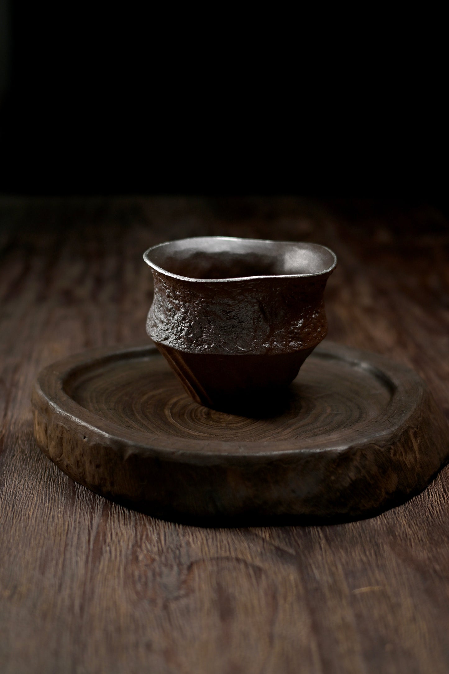 Hand-shaped rustic tea rinsing bowl made from natural coarse clay with earthy tones and tactile surface